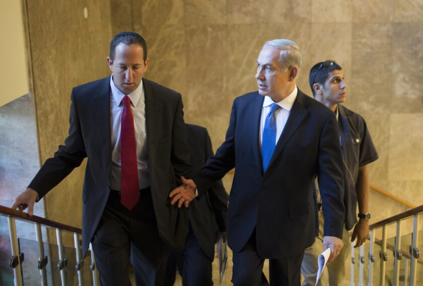 Israeli Prime Minister Benjamin Netanyahu, right, arrives at the weekly Cabinet meeting in his Jerusalem office on Sunday.