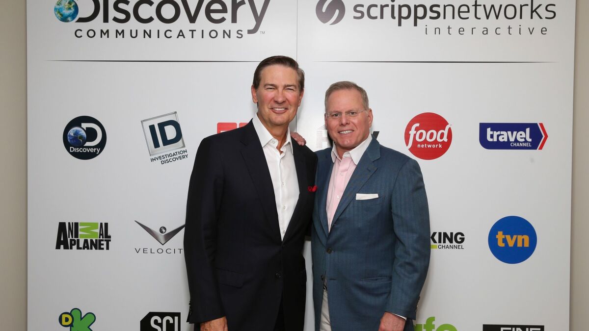 Discovery on Tuesday finalized its deal to acquire Scripps Networks Interactive, formerly run by Kenneth W. Lowe, left. With him is Discovery Chief Executive David Zaslav, who will run the new enterprise.