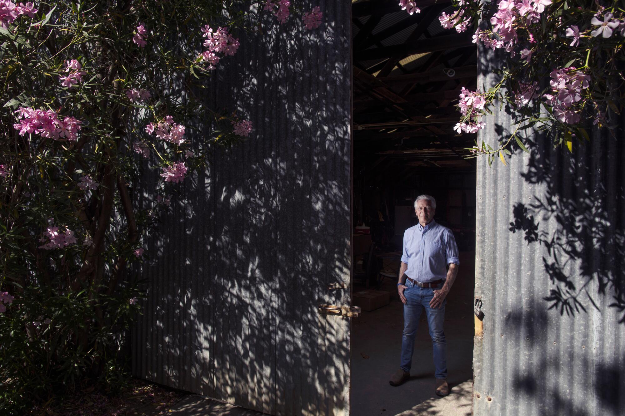 Walnut farmer Craig McNamara stands in his barn in Winters, Calif.