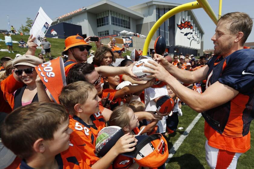Denver Broncos quarterback Case Keenum signs autographs after at NFL football training camp Tuesday, Aug. 7, 2018, in Englewood, Colo. (AP Photo/David Zalubowski)