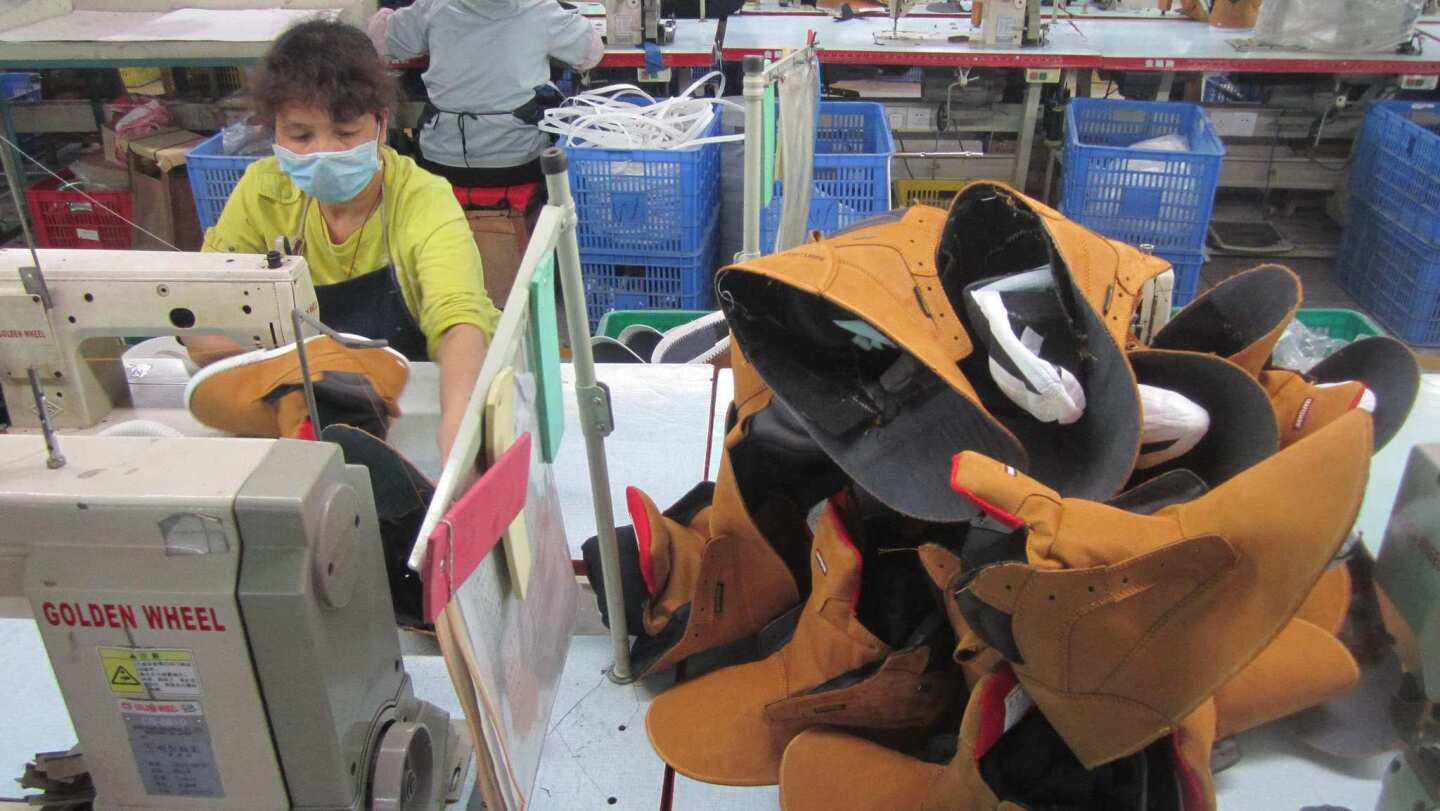 Workers make specialty footwear such as fire retardant boots and steel-toed shoes at Tony Zhang's factory in Huizhou, a city in southern China.