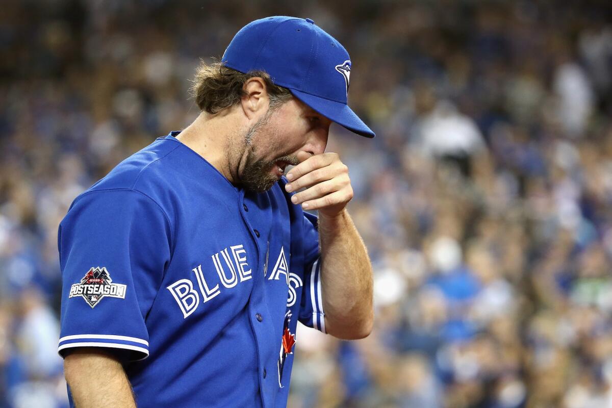 Toronto right-hander R.A. Dickey walks off the field after being relieved in the second inning against the Kansas City during Game 4 of the American League Championship Series.