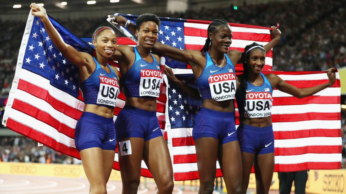 The U.S. 1,600-meter relay team (from left) of Allyson Felix, Phyllis Francis, Shakima Wimbley and Quanera Hayes celebrate after winning gold at the world championships on Sunday.