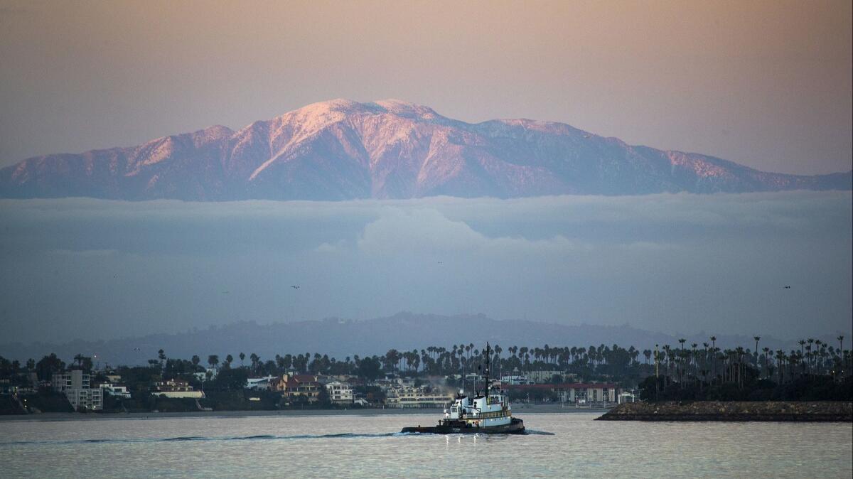 Search-and-rescue teams are fanning out across the Mt. Baldy area for two hikers who have been missing since Saturday. A snow-capped Mt. Baldy is seen here from Catalina Island in January.