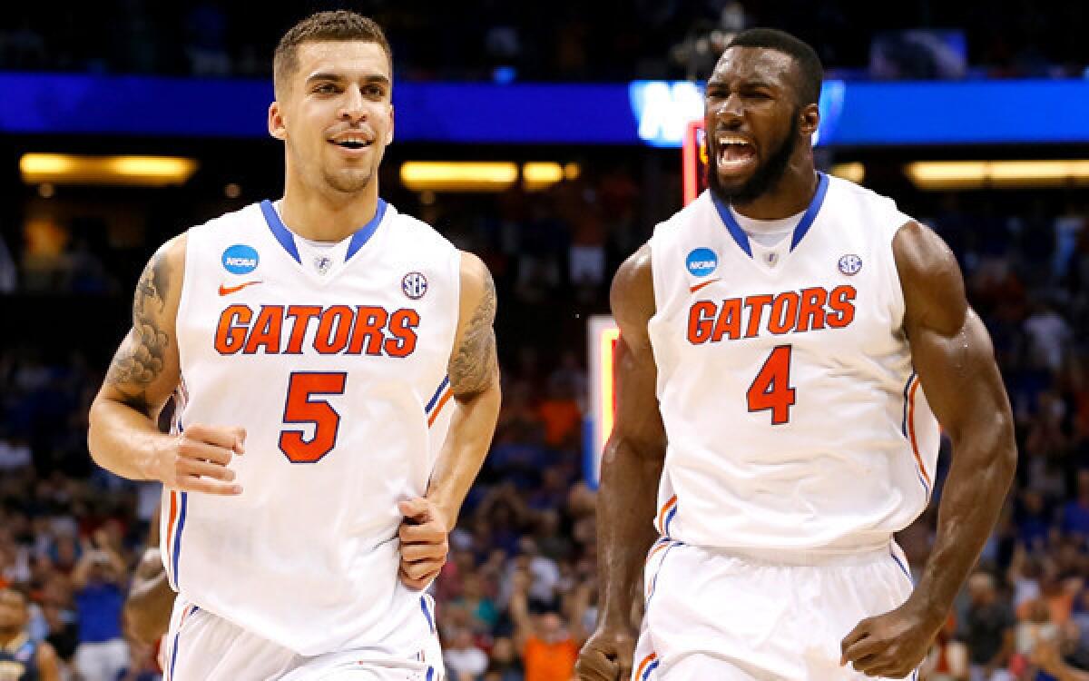Center Patric Young (4) and point guard Scottie Wilbekin (5 ) form a stellar inside-out combination for Florida. They are two of four seniors in the starting lineup.