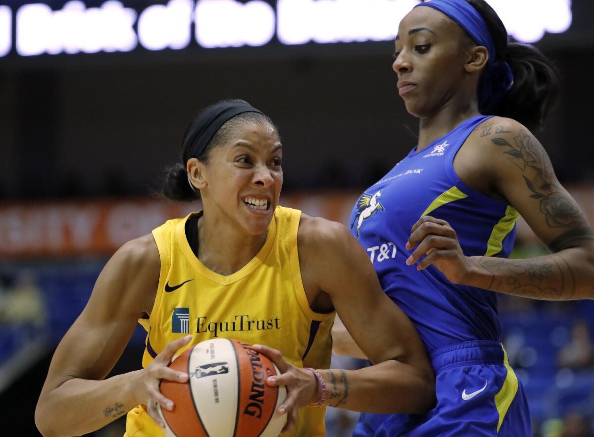 Sparks forward Candace Parker, left, drives to the basket against Dallas Wings' Glory Johnson, right, in the first half on Wednesday in Arlington, Texas.