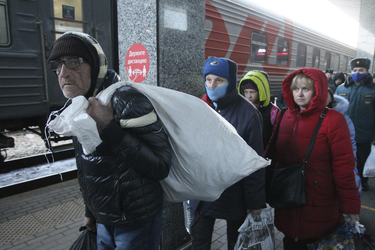 People from Mariupol and eastern Ukraine disembark from a train.