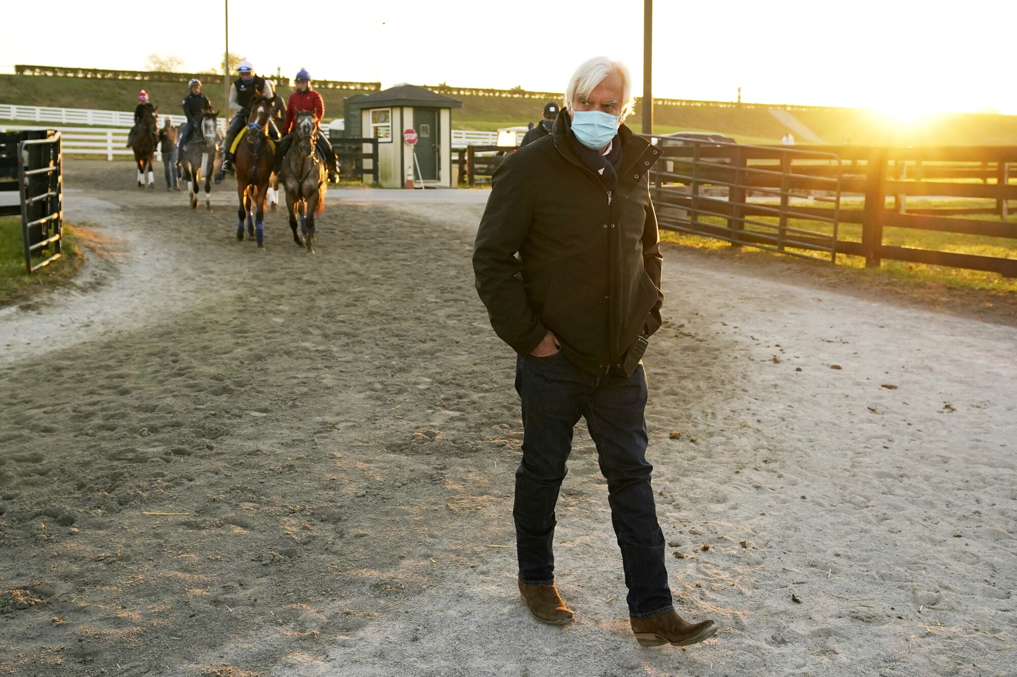 Horse trainer Bob Baffert walks through the stable area during morning workouts for the Breeders' Cup World Championship.