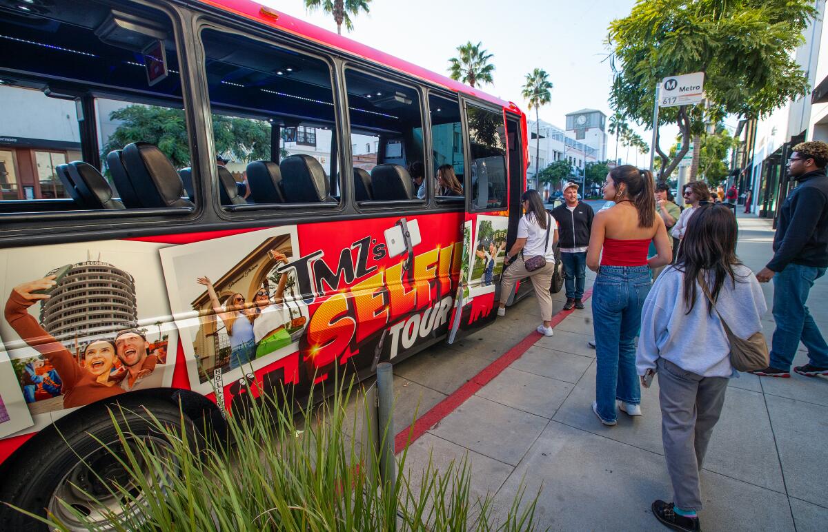 People board the bus in Beverly Hills, before heading to the next stop on the TMZ "Selfie Tour."