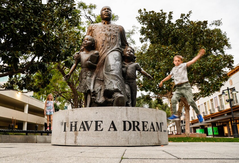 A youngster leaps off the Martin Luther King “I Have a Dream” statue