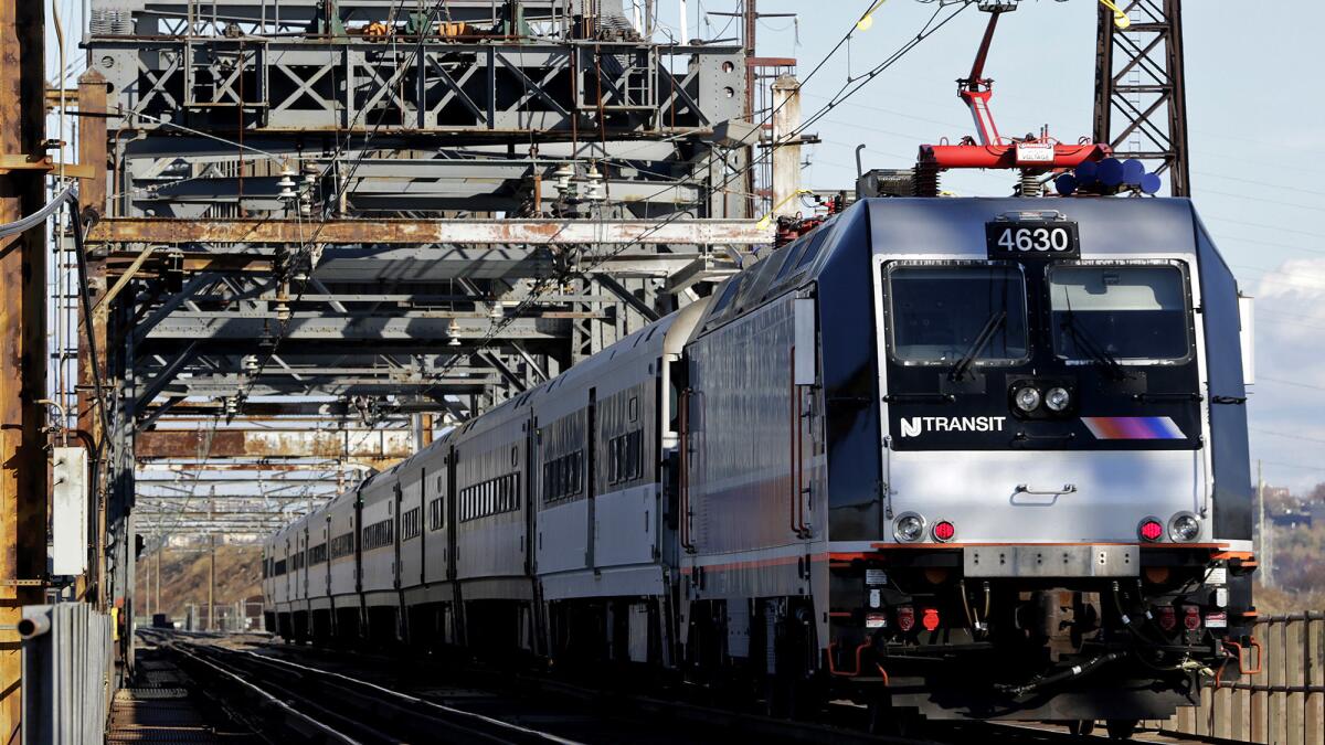 A New Jersey Transit train travels across Portal Bridge in Kearny, N.J., in 2014. Plans call for a pair of replacement bridges for the 105-year-old structure.