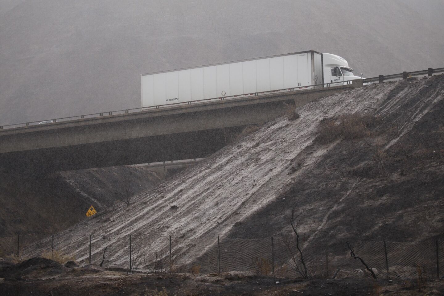 Vehicles are slowed for miles on both North and South bound lanes of the 101 Freeway at Solimar Beach in western Ventura County as mud from the recent Solimar fire covers all lanes Tuesday morning.