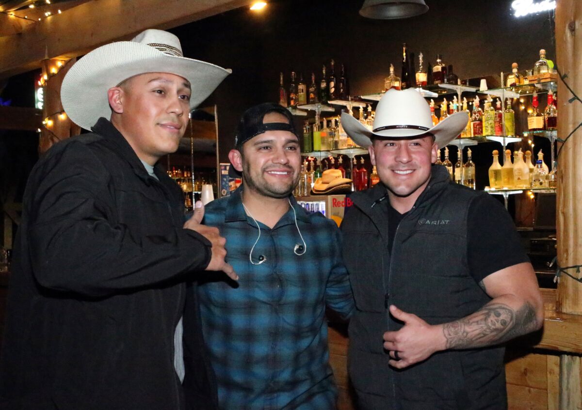Country singer Frank Ray, center, poses for a photo with Alex Solis, left, and Joseph Daniels, both of Las Cruces, N.M., at a concert at Whiskey Dicks nightclub.