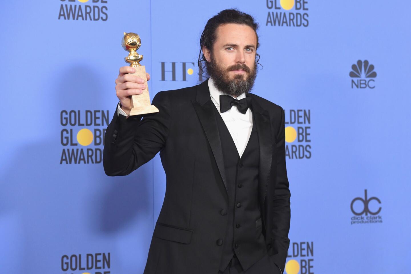 Casey Affleck with his award for actor in a motion picture drama for "Manchester by the Sea."