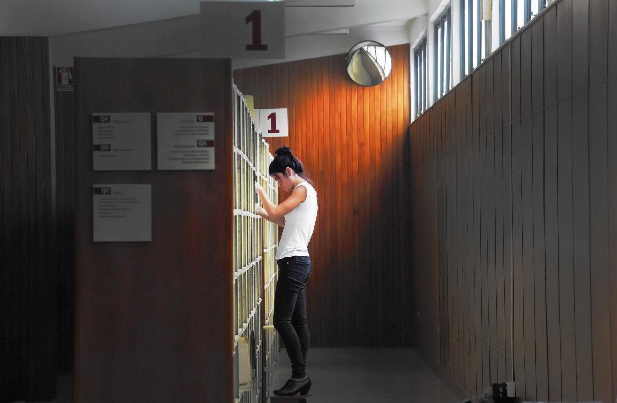 A student at the sciences library at Central University of Venezuela, which has been closed since September because of what administrators say are funding woes.