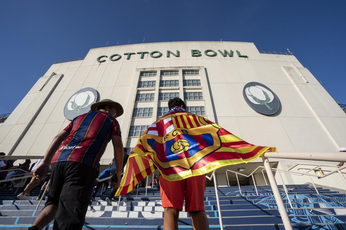 FILE - Fans of FC Barcelona walk into the Cotton Bowl before a soccer match against Juventus Tuesday, July 26, 2022 in Dallas. (AP Photo/Jeffrey McWhorter, File)