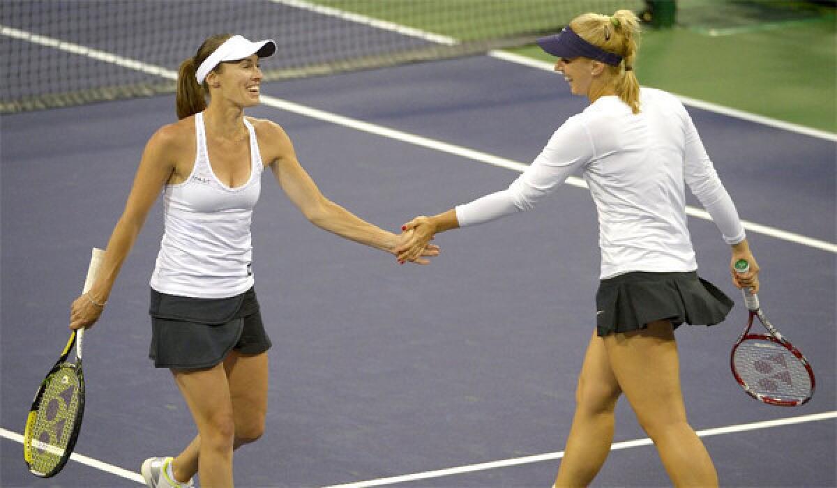Martina Hingis of Switzerland shakes hands with her doubles partner Sabine Lisicki of Germany during a three set loss to Ashleigh Barty and Casey Dellacqua of Australia, 6-4, 6-7 (0) 10-6, at the BNP Paribas Open in Indian Wells, Calif.