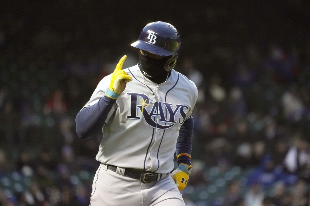 Tampa Bay Rays' Wander Franco looks at his teammates as he celebrates his two-run home run off Chicago Cubs starting pitcher Justin Steele during the third inning of a baseball game Tuesday, April 19, 2022, in Chicago. (AP Photo/Charles Rex Arbogast)