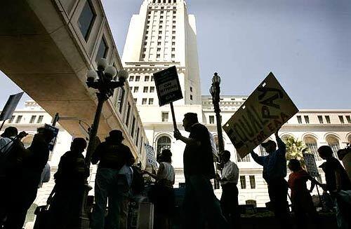 Picketers at City Hall are among the more than 1,500 municipal employees who walked out Tuesday as part of a strike by the Engineers and Architects Assn. The action did not disrupt daily life across L.A.