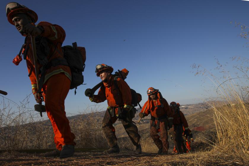 REDLANDS, CA - OCTOBER 15: Cal Fire inmate crew returns after overnight duty at Bruder fire that burned over 100 acres in South Redlands on Thursday morning. Brush fire dubbed, Bruder fire, started on Wednesday night and forced evacuation around Bruder Lane and Helen Drive on Thursday, Oct. 15, 2020 in Redlands, CA. (Irfan Khan / Los Angeles Times)