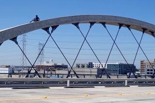 A woman in her mid 20s was seen climbing and dancing on top of one of the arches on the 6th Street Bridge Thursday morning.