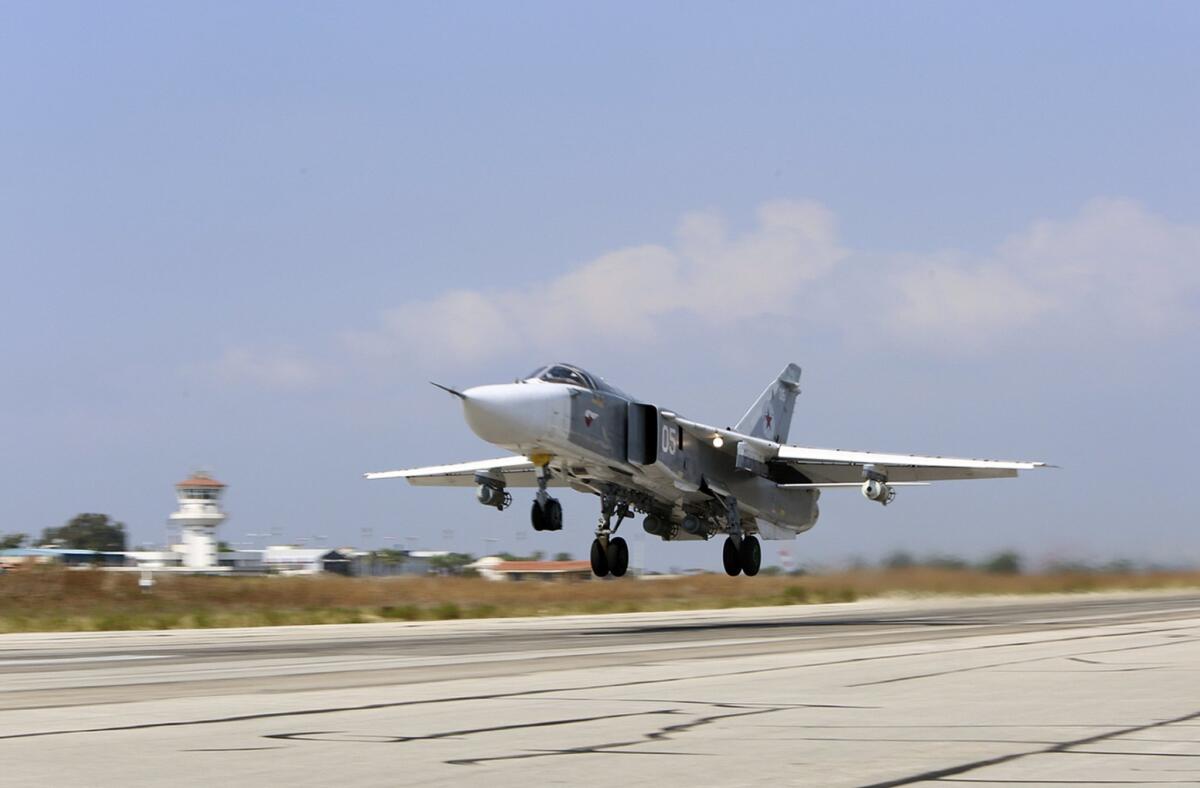 A Russian SU-24M jet fighter armed with laser-guided bombs takes off from Hmeimim air base in Syria on Oct. 3.