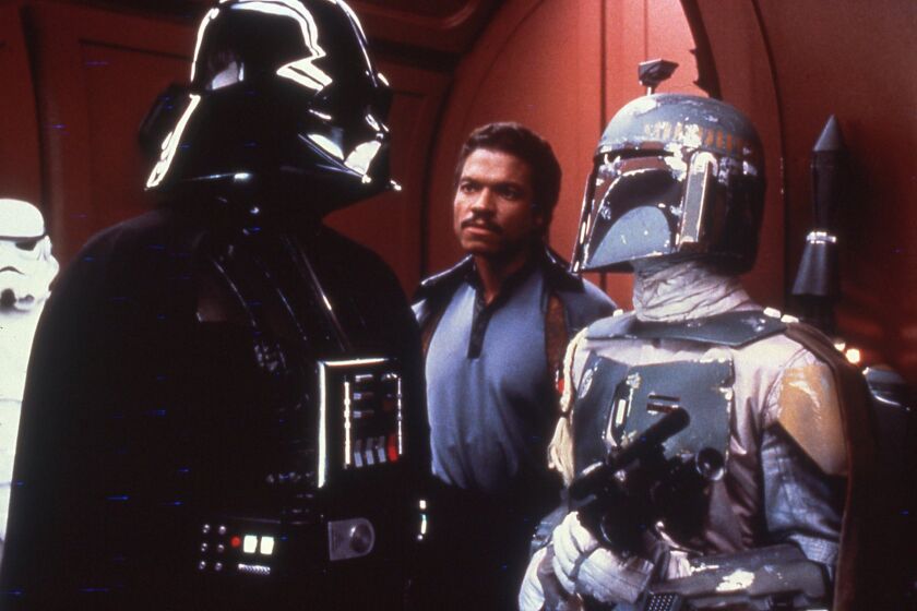 (L-R) - Darth Vader (David Prowse) confronts Lando Calrissian (Billy Dee Wiliams) and Boba Fett in a scene from "The Empire Strikes Back." Credit: Lucasfilm Ltd.