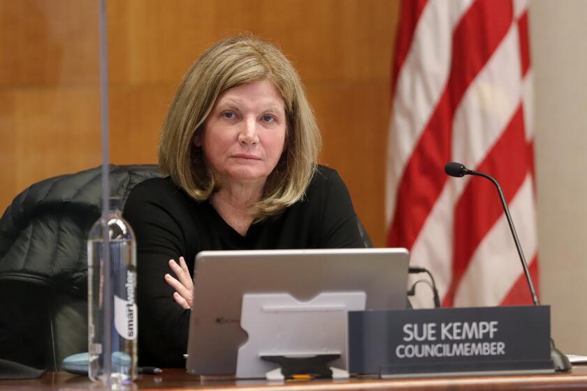 Laguna Beach City Council member Sue Kempf takes her seat during Tuesday's in-chambers meeting, the first since the city council has been on the dais together since the modifications and closures were made due to the coronavirus pandemic.