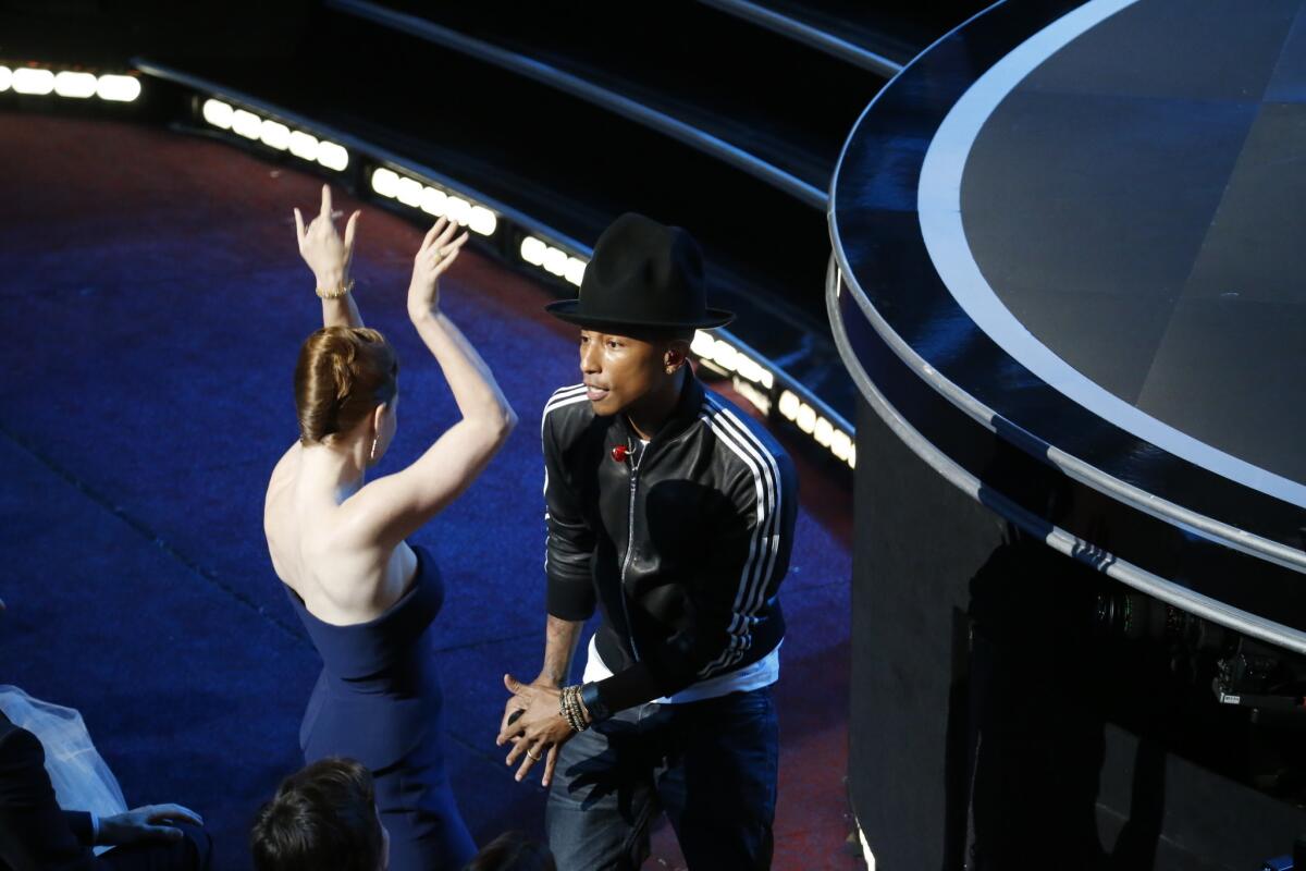 Pharrell Williams, dancing with Amy Adams as he works the crowd, sings "Happy" from "Despicable Me 2."