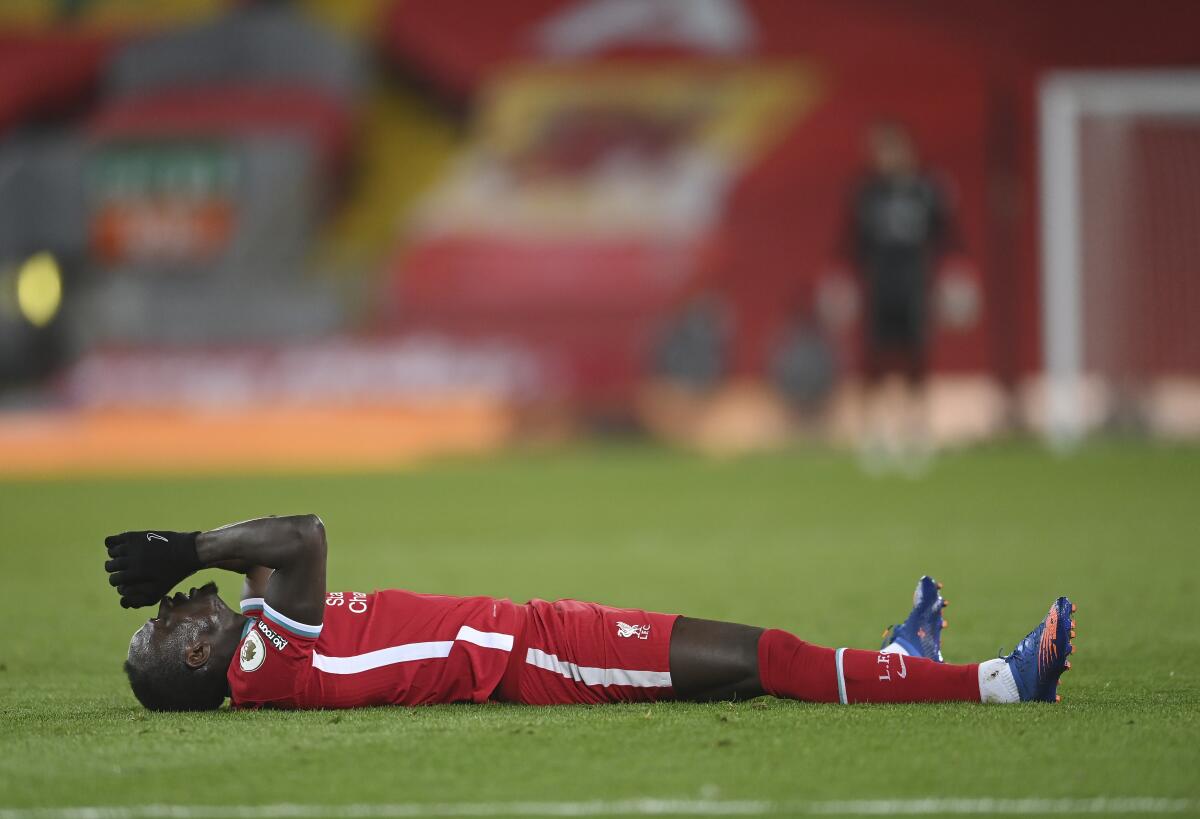 Liverpool's Sadio Mane lies on the field during the English Premier League soccer match between Liverpool and Chelsea at Anfield stadium in Liverpool, England, Thursday, March 4, 2021. (Laurence Griffiths, Pool via AP)