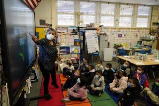 Kindergarten teacher Ana Zavala, at left, instructs students amid the COVID-19 pandemic at Washington Elementary School Wednesday, Jan. 12, 2022, in Lynwood, Calif. California is making it easier for school districts to hire teachers and other employees amid staffing shortages brought on by the latest surge in coronavirus cases. (AP Photo/Marcio Jose Sanchez)