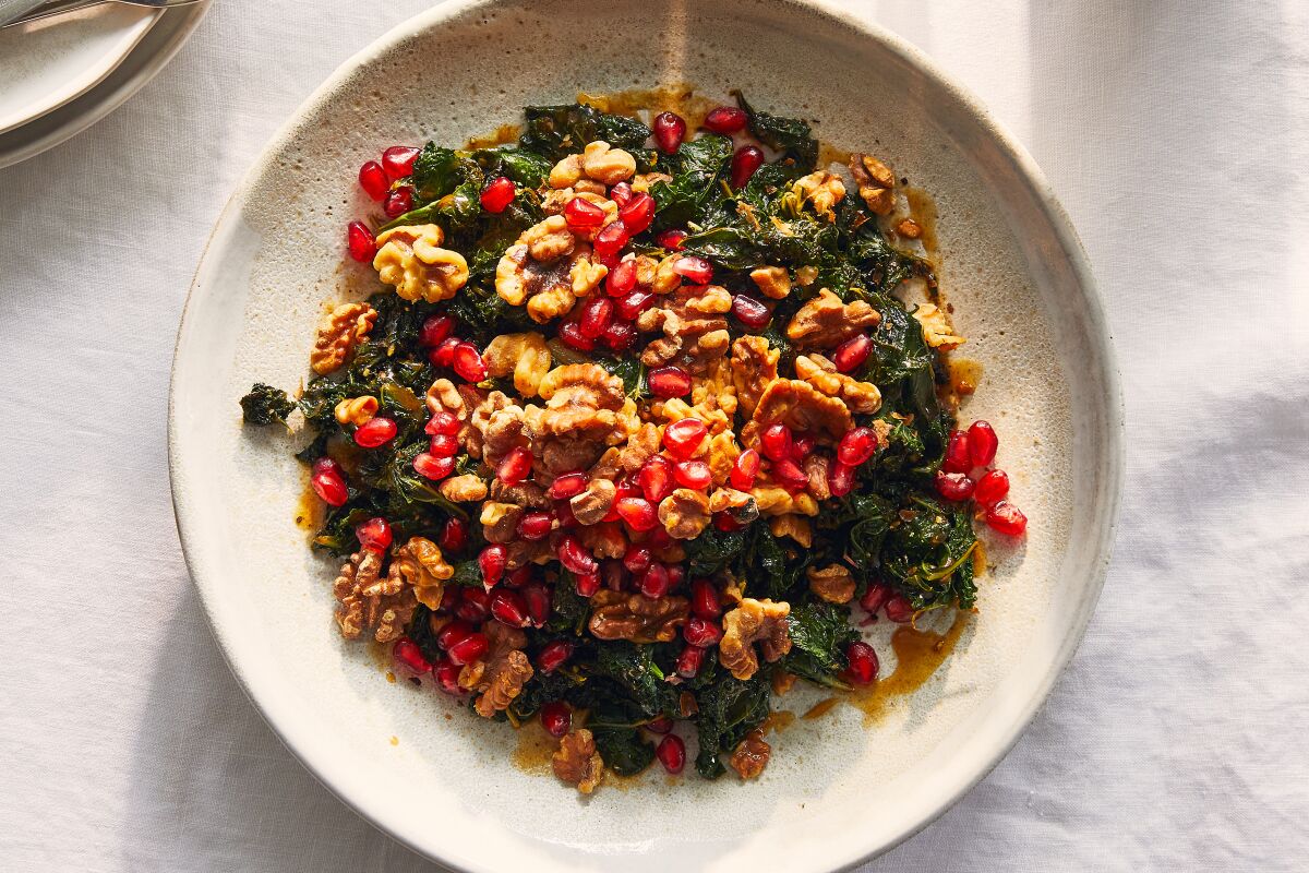 Warm kale salad with walnuts and pomegranate.