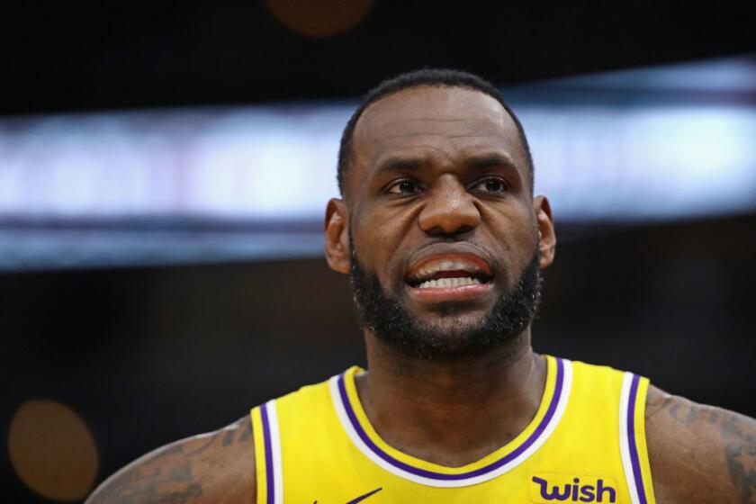 CHICAGO, ILLINOIS - MARCH 12: LeBron James #23 of the Los Angeles Lakers talks with a teammate during a game against the Chicago Bulls at the United Center on March 12, 2019 in Chicago, Illinois. The Lakers defeated the Bulls 123-107. NOTE TO USER: User expressly acknowledges and agrees that, by downloading and or using this photograph, User is consenting to the terms and conditions of the Getty Images License Agreement. (Photo by Jonathan Daniel/Getty Images)