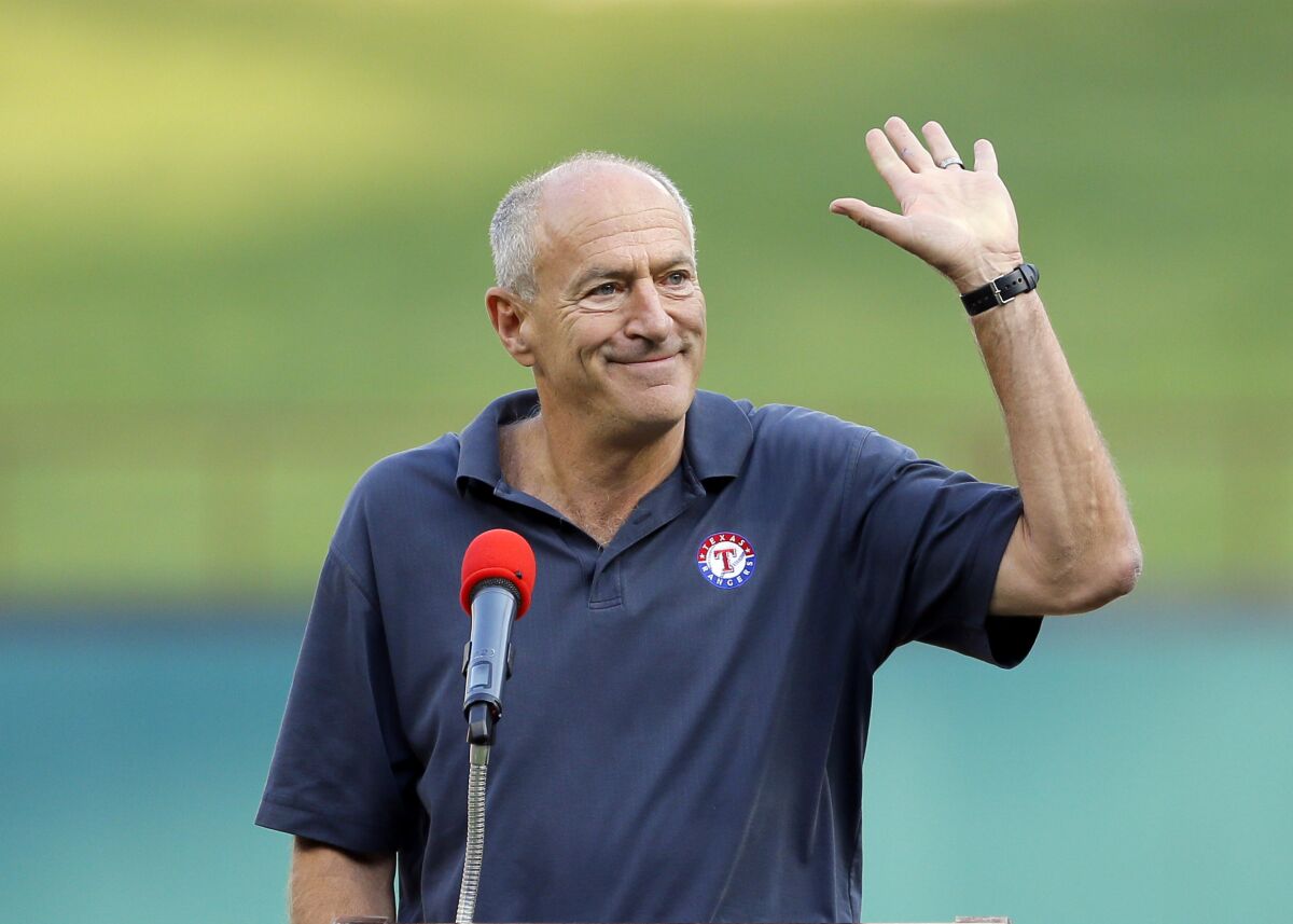 FILE -Texas Rangers radio sports announcer Eric Nadel waves to cheering fans as he emcee's a pregame ceremony honoring Adrian Beltre before a baseball game against the New York Yankees on Friday, Sept. 8, 2017, in Arlington, Texas. Hall of Fame broadcaster Eric Nadel said Wednesday, March 22, 2023 that he will miss the start of his 29th season as the lead voice on Texas Rangers radio broadcasts while getting treatment for some mental health issues. (AP Photo/Tony Gutierrez, File)