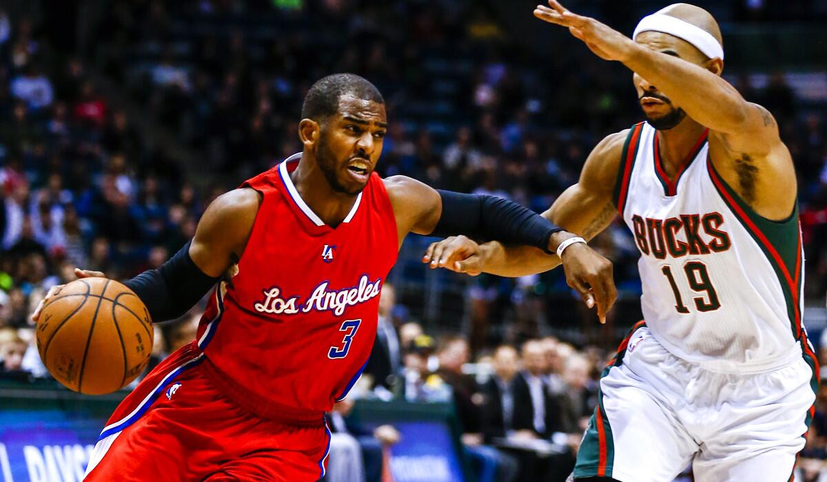 Clippers point guard Chris Paul tries to drive past Bucks guard Jerryd Bayless in the first half Saturday in Milwaukee.