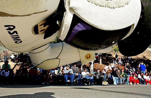 The giant Honda robot dips to within a few feet of the street in order to squeeze beneath a freeway overpass near the end of the Rose Parade in Pasadena. Complete Rose Parade coverage