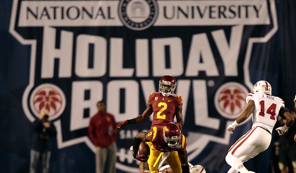 USC receiver Juju Smith can't escape the tackle of Nebraska during the second half action of the Holiday Bowl at Qualcomm Stadium on Dec. 27, 2014.