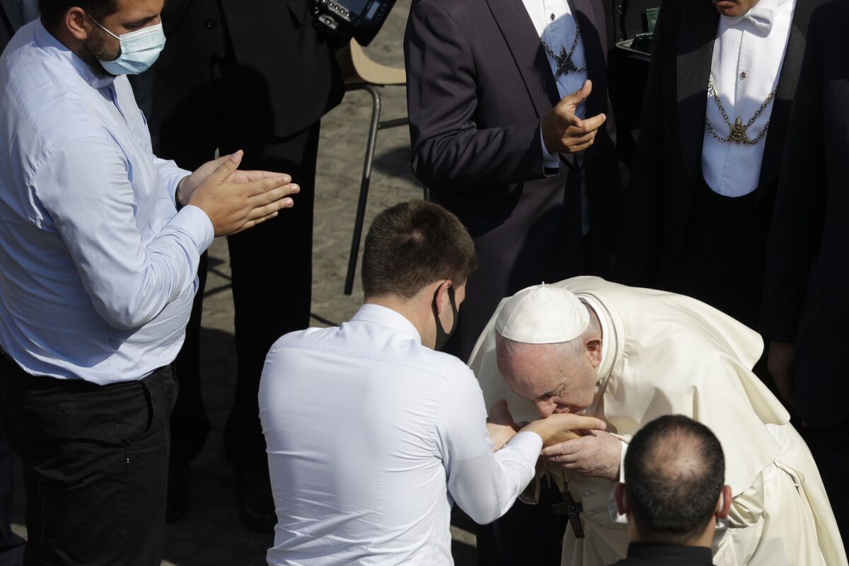Pope Francis blesses newly ordained priests in the St. Damaso courtyard on the occasion of the weekly general audience at the Vatican, Wednesday, Sept. 16, 2020. (AP Photo/Gregorio Borgia)