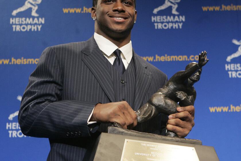 FILE - Heisman Trophy winner Reggie Bush of the University of Southern California smiles while posing for photos after a news conference in New York, Dec. 10, 2005. Reggie Bush has been reinstated as the 2005 Heisman Trophy winner, Wednesday, April 24, 2024, more than a decade after Southern California returned the award following an NCAA investigation that found he received what were impermissible benefits during his time with the Trojans.(AP Photo/Frank Franklin II, File)