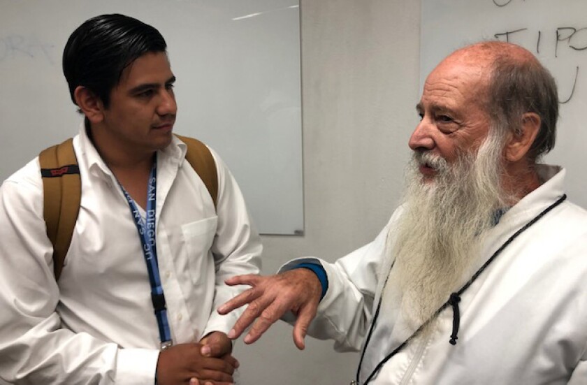 Father Flor Rigoni (right), an advocate for migrants, speaks with student Arzu Saucedo at UCSD Tuesday, July 30, 2019.