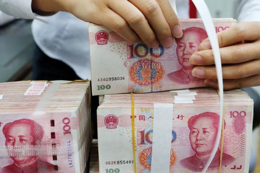 An employee packages 100-yuan notes at a bank in Nantong in China's eastern Jiangsu province on July 23, 2018. China on July 23 rejected accusations by US President Donald Trump that it was manipulating the yuan to give its exporters an edge, saying Washington appeared "bent on provoking a trade war". / AFP PHOTO / - / China OUT-/AFP/Getty Images ** OUTS - ELSENT, FPG, CM - OUTS * NM, PH, VA if sourced by CT, LA or MoD **