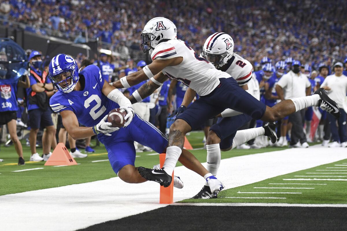 BYU wide receiver Neil Pau'u (2) scores a touchdown against Arizona during the second half of an NCAA college football game Saturday, Sept. 4, 2021, in Las Vegas. (AP Photo/David Becker)