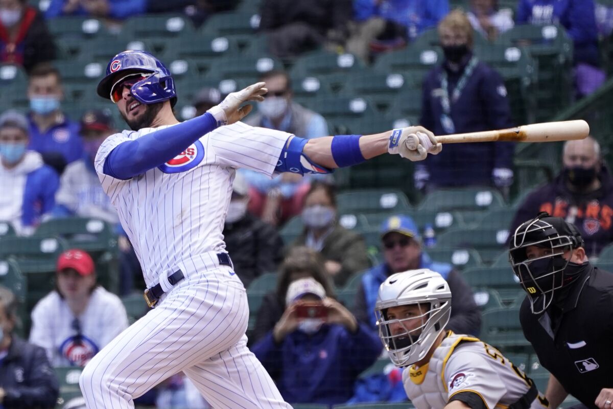 FILE - Chicago Cubs' Kris Bryant watches his hit during a baseball game against the Pittsburgh Pirates in Chicago, in this May 7, 2021, file photo. Bryant's versatility, while producing offensive numbers that belong alongside his NL MVP season in 2016, is a big reason why Chicago is on top of the NL Central once again, helping the Cubs go on a 21-9 run while dealing with a rash of injuries. (AP Photo/Charles Rex Arbogast, File)