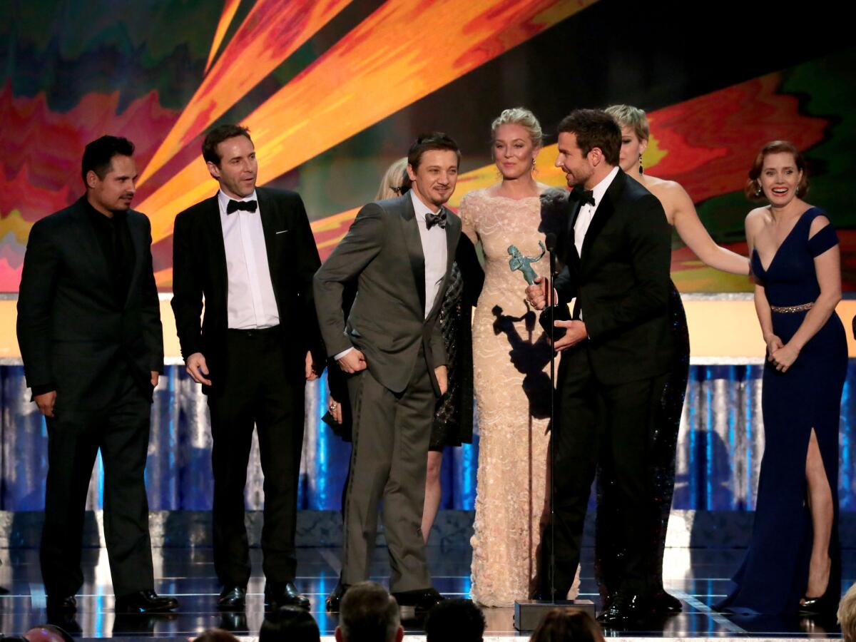 Actors Jeremy Renner, Bradley Cooper, Elisabeth Rohm and Jennifer Lawrence accept the performance by a cast in a motion picture award for "American Hustle."
