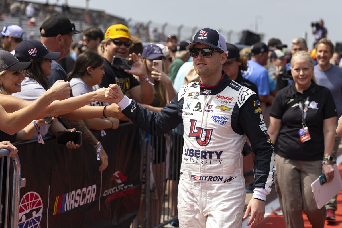 William Byron greets fans before a NASCAR Cup Series auto race at Circuit of the Americas, Sunday, March 26, 2023, in Austin, Texas. (AP Photo/Stephen Spillman)