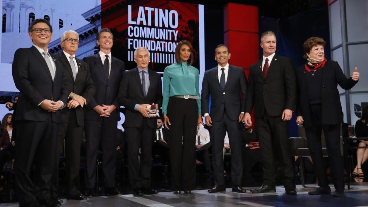 John Chiang, from left, John Cox, Gavin Newsom, debate hosts Jorge Ramos and Ilia Calderon, Antonio Villaraigosa, Travis Allen and Delaine Eastin.