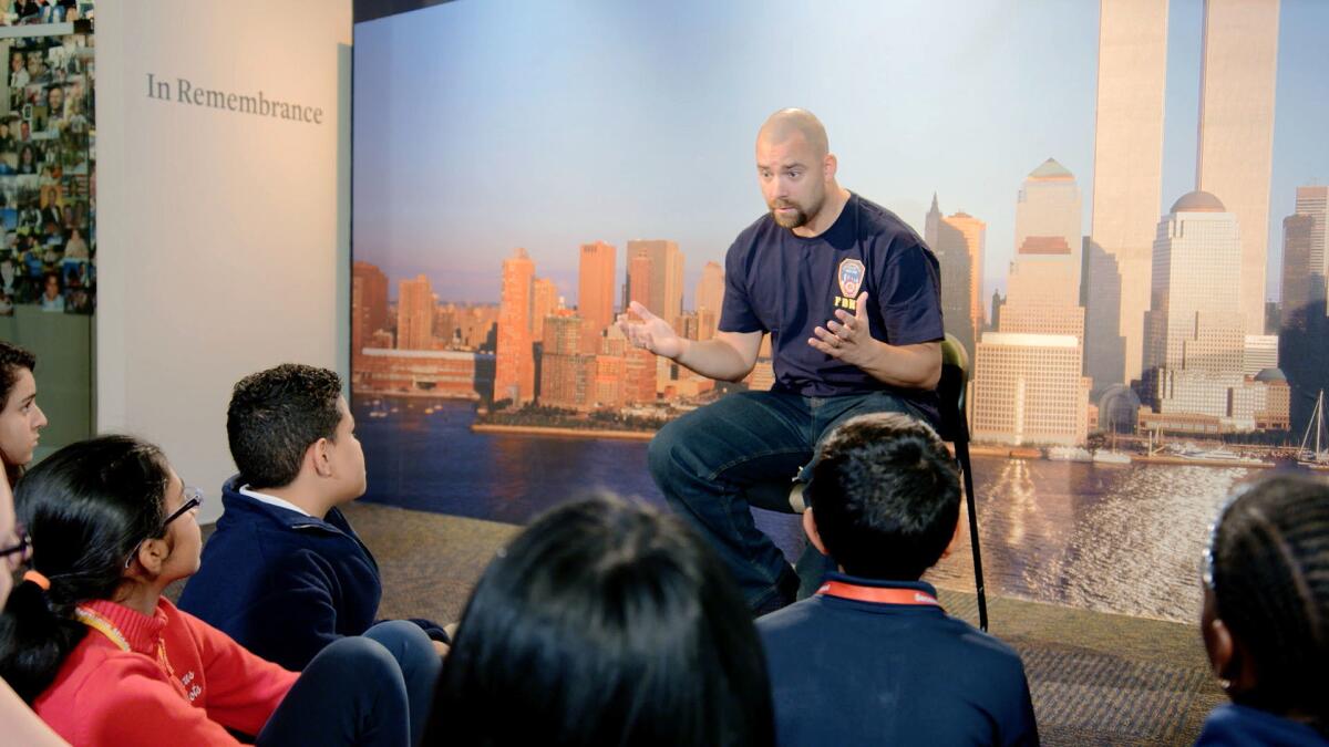 A New York City fireman speaks to children in a scene from the documentary "What Happened on September 11."