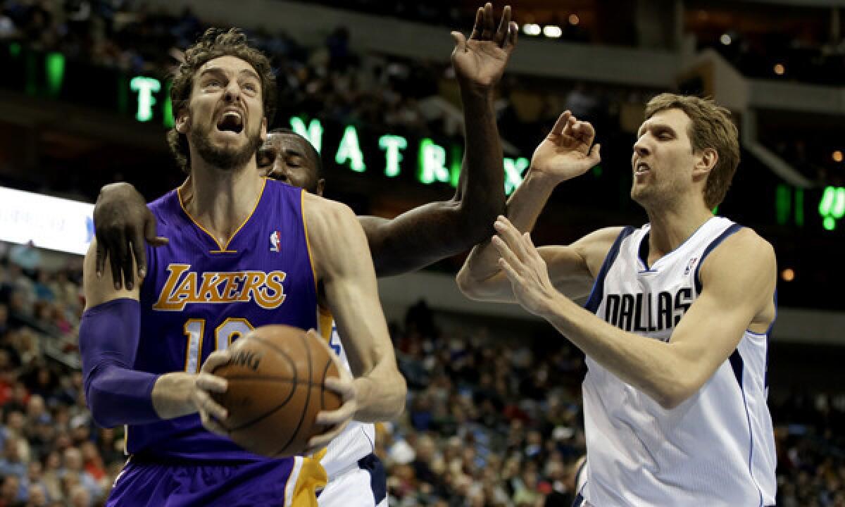 Lakers center Pau Gasol, left, drives to the basket in front of Dallas Mavericks teammates DeJuan Blair, center, and Dirk Notwitzki during the first half of Tuesday's game.