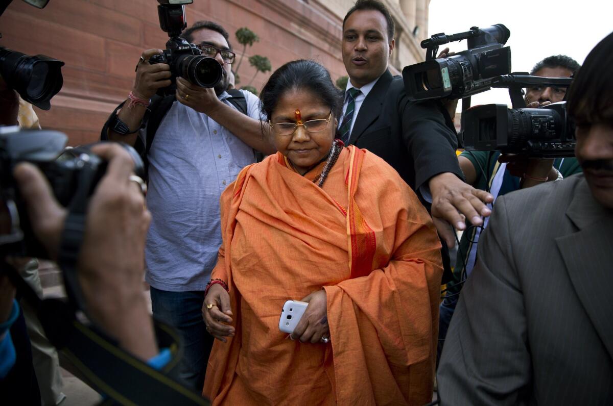 Junior minister Sadhvi Niranjan Jyoti is chased by the press as she walks out of the Indian parliament in New Delhi on Dec. 5. Prime Minister Narendra Modi rejected calls to fire her over derogatory comments she made about Muslims.