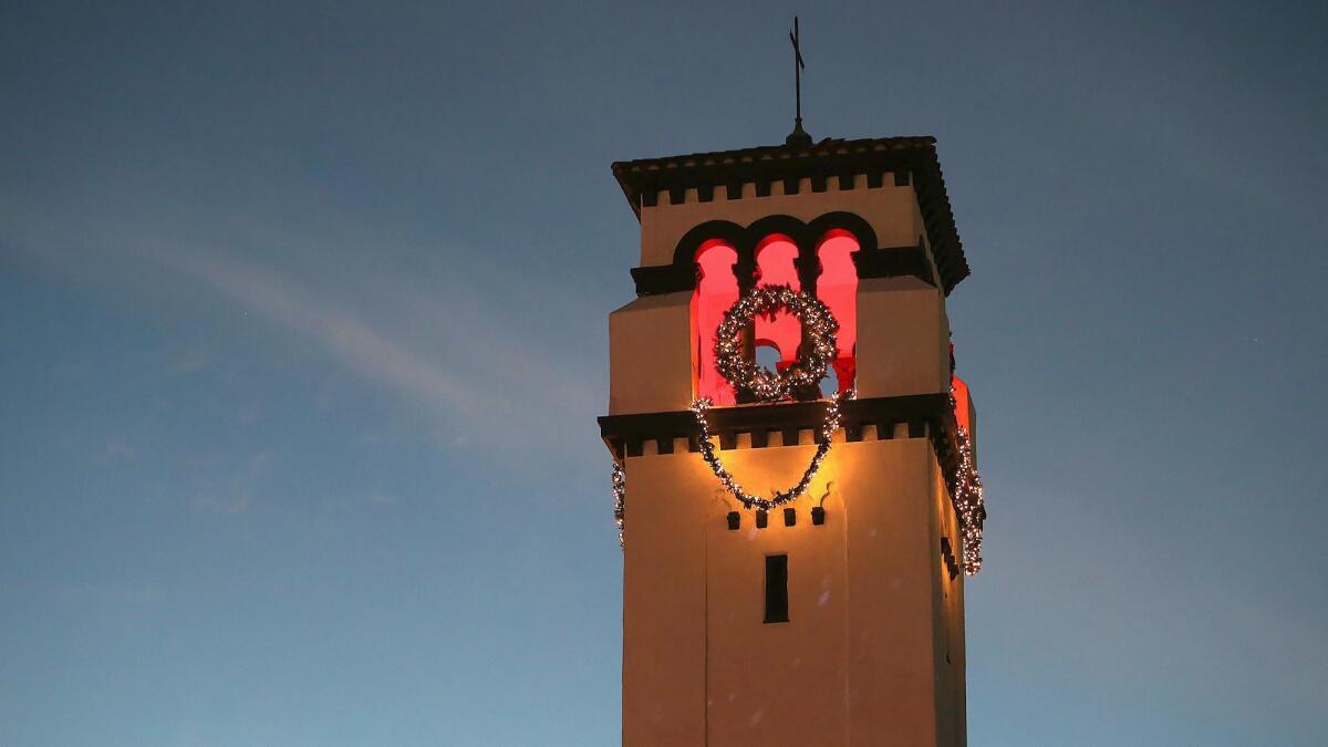 The lighted 1927 bell tower at First United Methodist Church in Costa Mesa is pictured Monday evening.